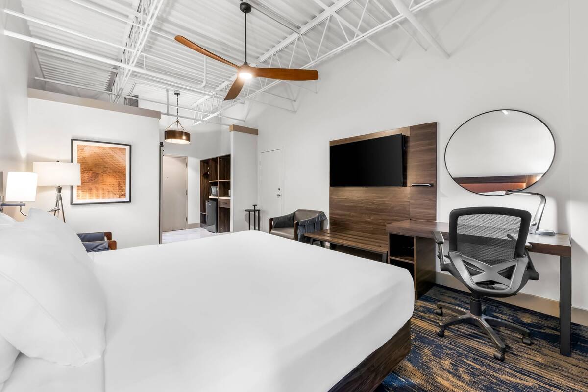 Hypo-allergenic bedding, desk, laptop workspace, blackout curtains