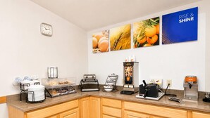 A breakfast bar with coffee machines, a toaster, and a syrup dispenser. - Comfort Inn Iron Mountain North (Iron Mountain)