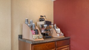 A coffee station with a coffee machine, cups, and a kettle. - Red Roof Inn Virginia Beach (Virginia Beach)