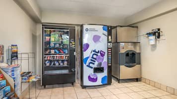 A vending machine with a variety of snacks and a push button.