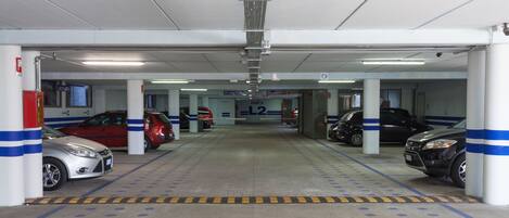 A multi-level parking garage with several cars parked.