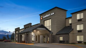 A Comfort Inn hotel with a stone facade, large windows, and a covered entrance. - Comfort Inn Metro Airport (Romulus)
