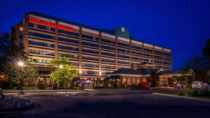 A large, multi-story hotel with a prominent sign reading "Hilton Garden Inn."