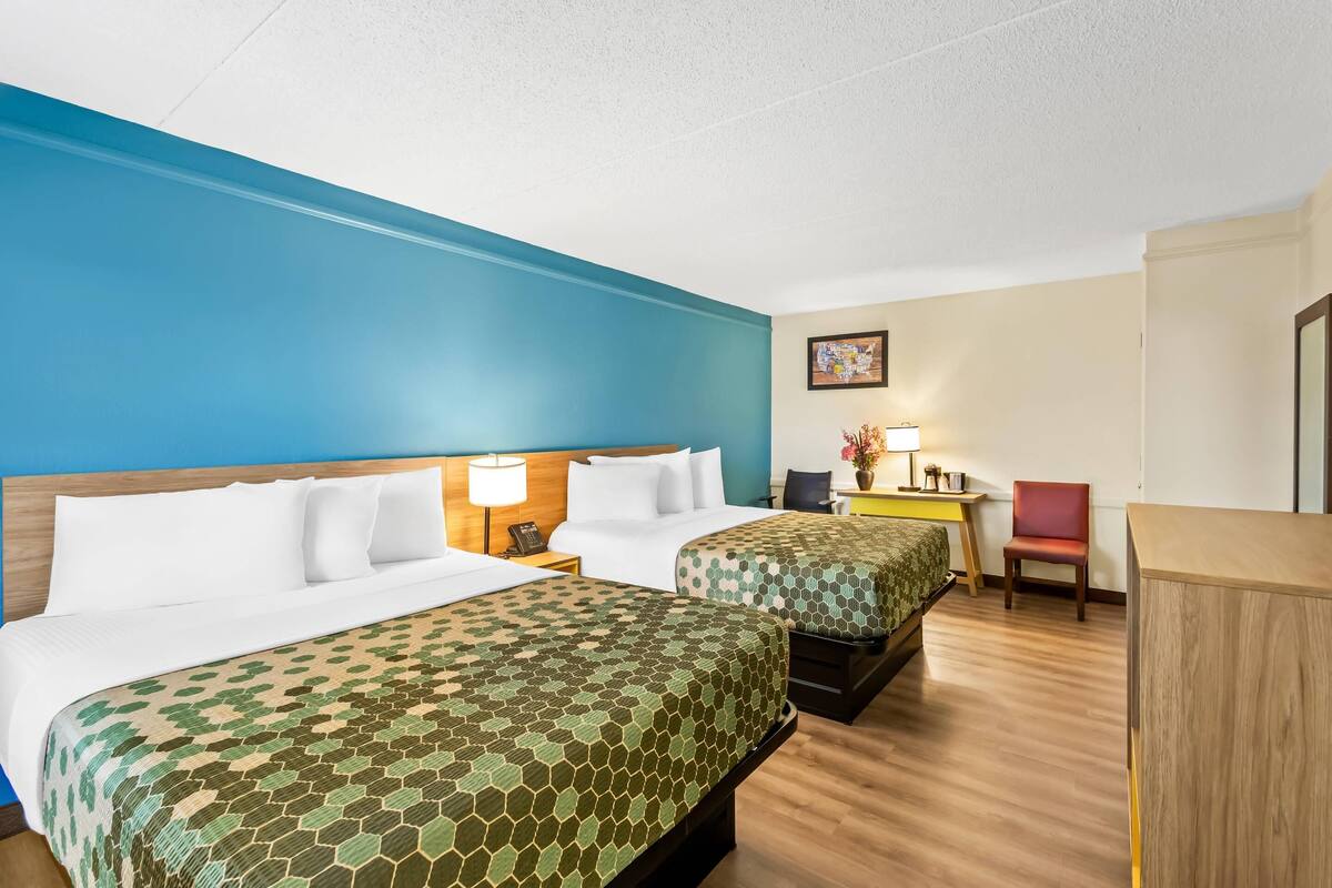 Premium bedding, desk, laptop workspace, blackout drapes