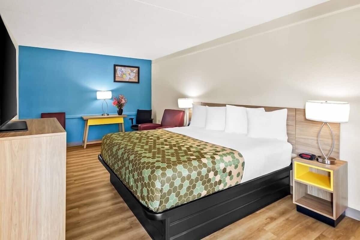 Premium bedding, desk, laptop workspace, blackout drapes