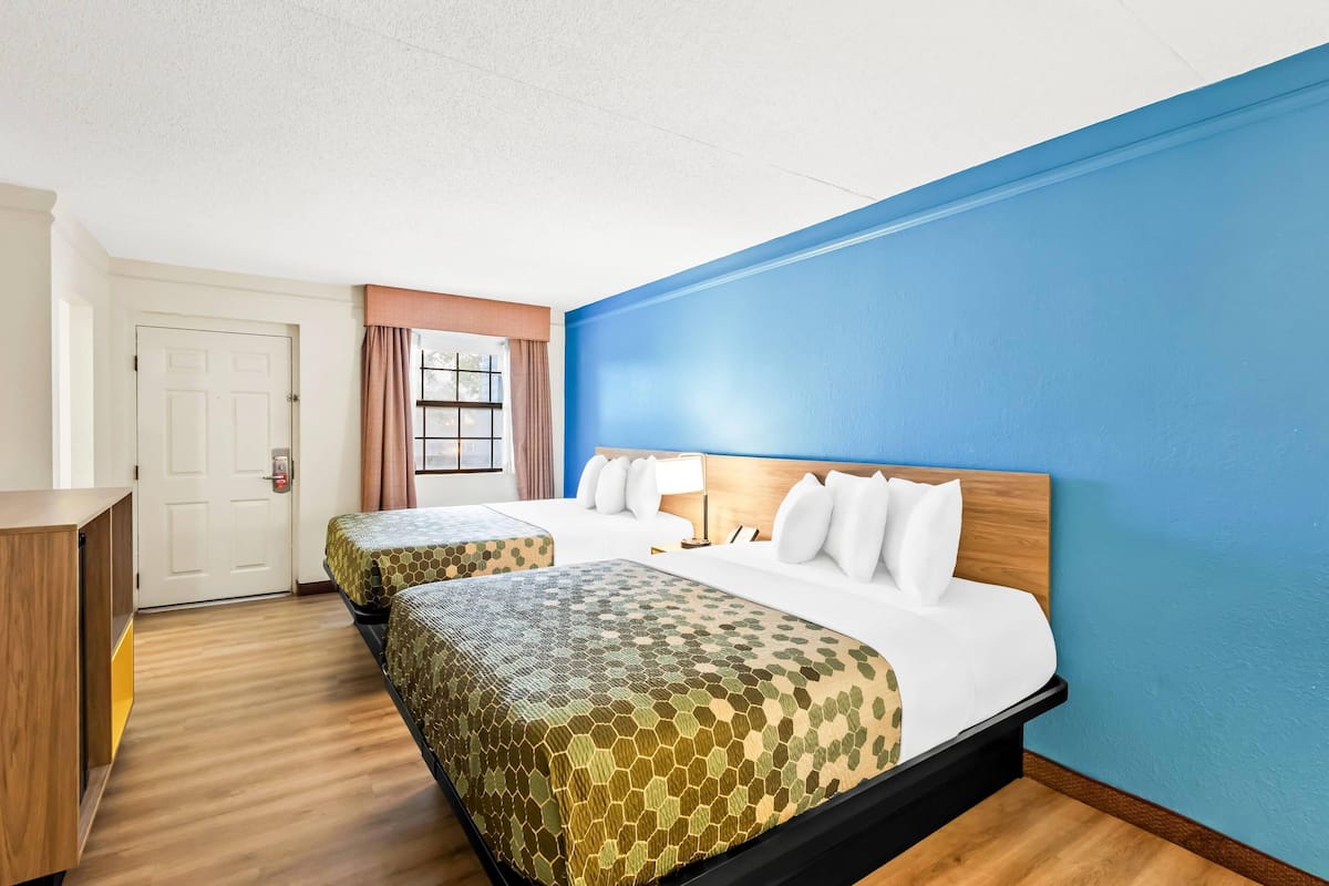 Premium bedding, desk, laptop workspace, blackout drapes