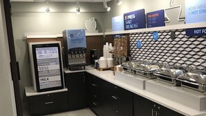 A modern breakfast bar with a digital menu board, coffee machines, and a variety of breakfast options. - Holiday Inn Express Allentown North by IHG (Allentown)