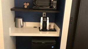 A compact kitchenette with a microwave, coffee maker, and trash bin. - Holiday Inn Express Allentown North by IHG (Allentown)
