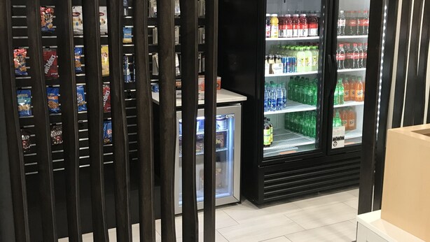 A section of a store with refrigerated beverage dispensers and shelves stocked with snacks. - Holiday Inn Express Allentown North by IHG (Allentown)