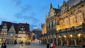 A historic building with ornate architecture and a large open plaza.