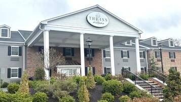 A hotel with a covered entrance, a sign reading "The Inn at Lehighburg", and a landscaped garden in front.