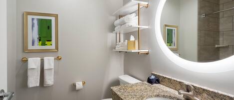 A modern bathroom with a toilet, sink, and towel rack.