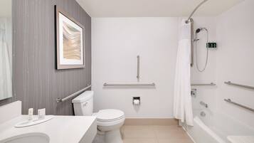 Un baño moderno con inodoro, lavamanos y bañera.