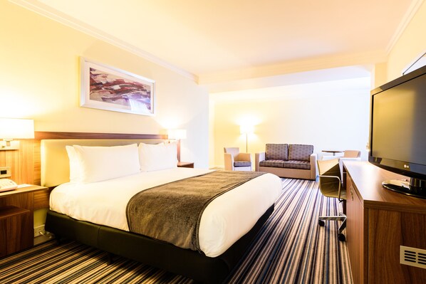 A hotel room with a bed, a desk, a television, and a chair. - Holiday Inn Portsmouth by IHG (Portsmouth)