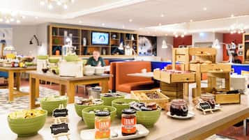 A buffet with various food items and condiments.