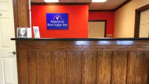 A reception desk with a sign for 'Americas Best Value Inn by Vantage'.