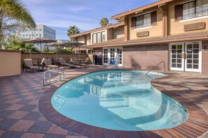 Outdoor pool, open 7:00 AM to 10:00 PM, pool umbrellas, pool loungers