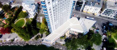 A high-rise hotel with multiple floors, a parking garage, and a waterfront view.