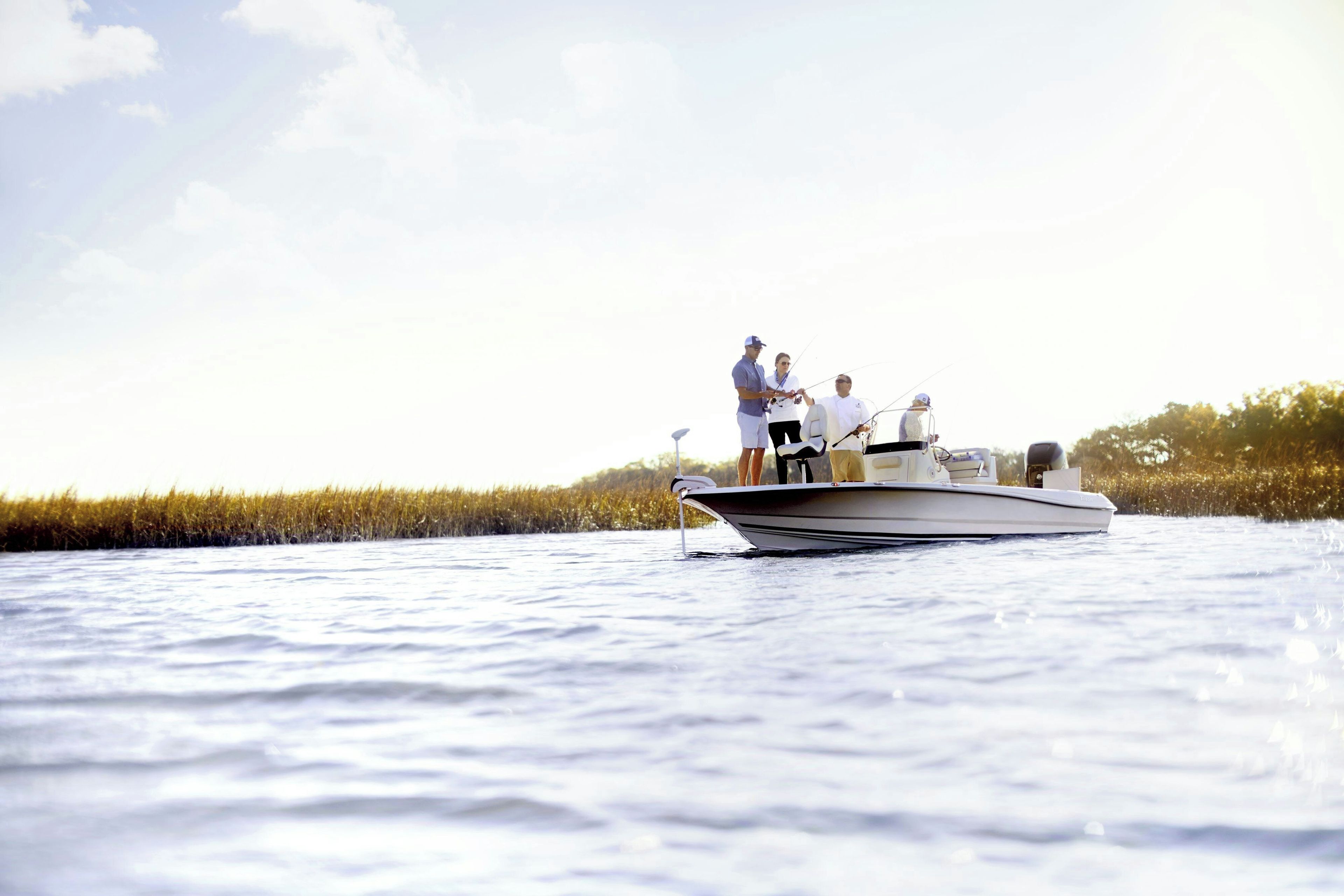 Un bateau sur l’eau, avec trois personnes à bord.