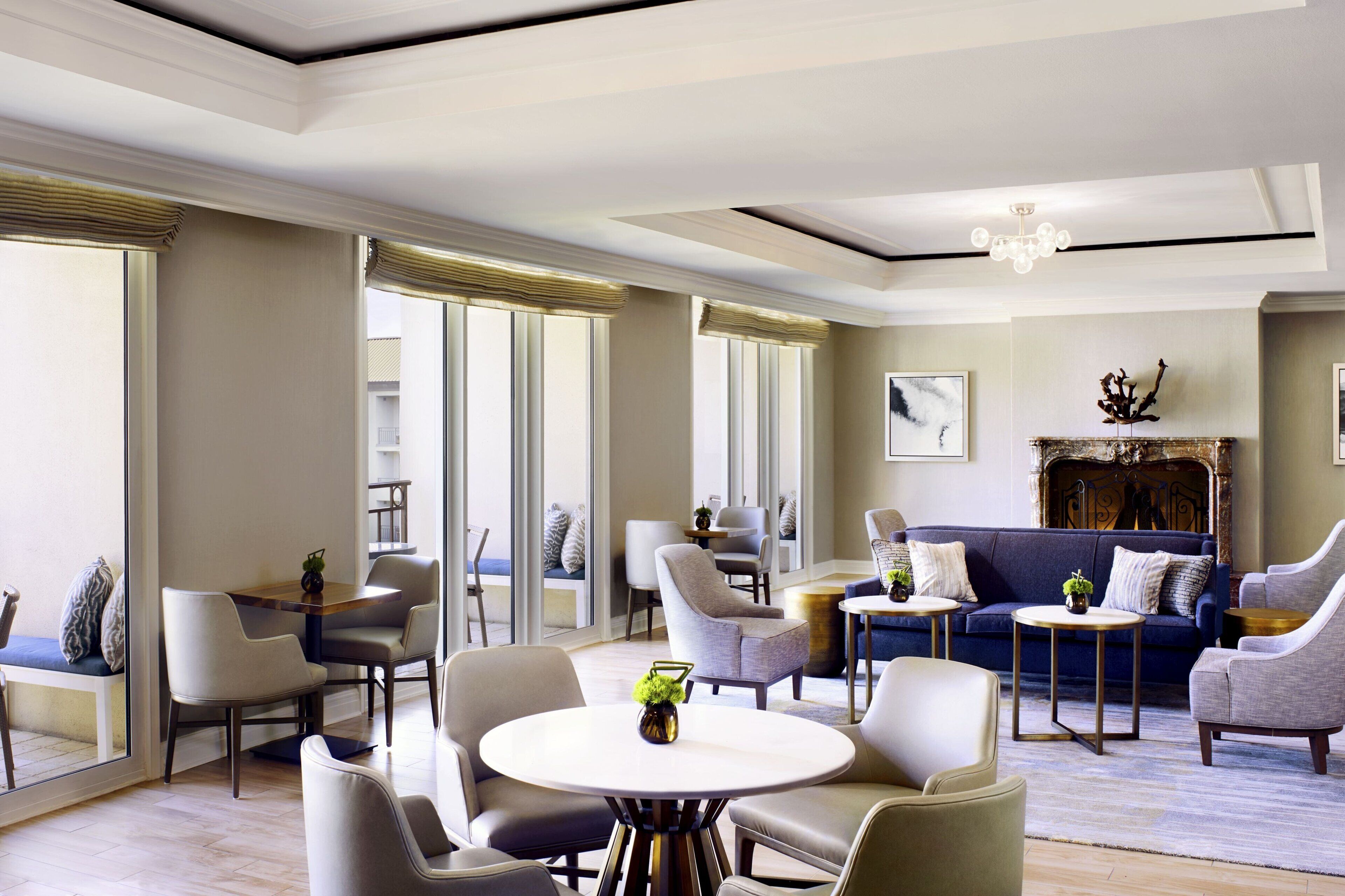 A modern living room with a sofa set, a dining table, and chairs.