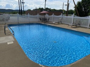 Seasonal outdoor pool, open 10:00 AM to 7:00 PM, pool umbrellas