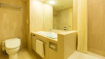 A bathroom with a toilet, sink, mirror, and bathtub.