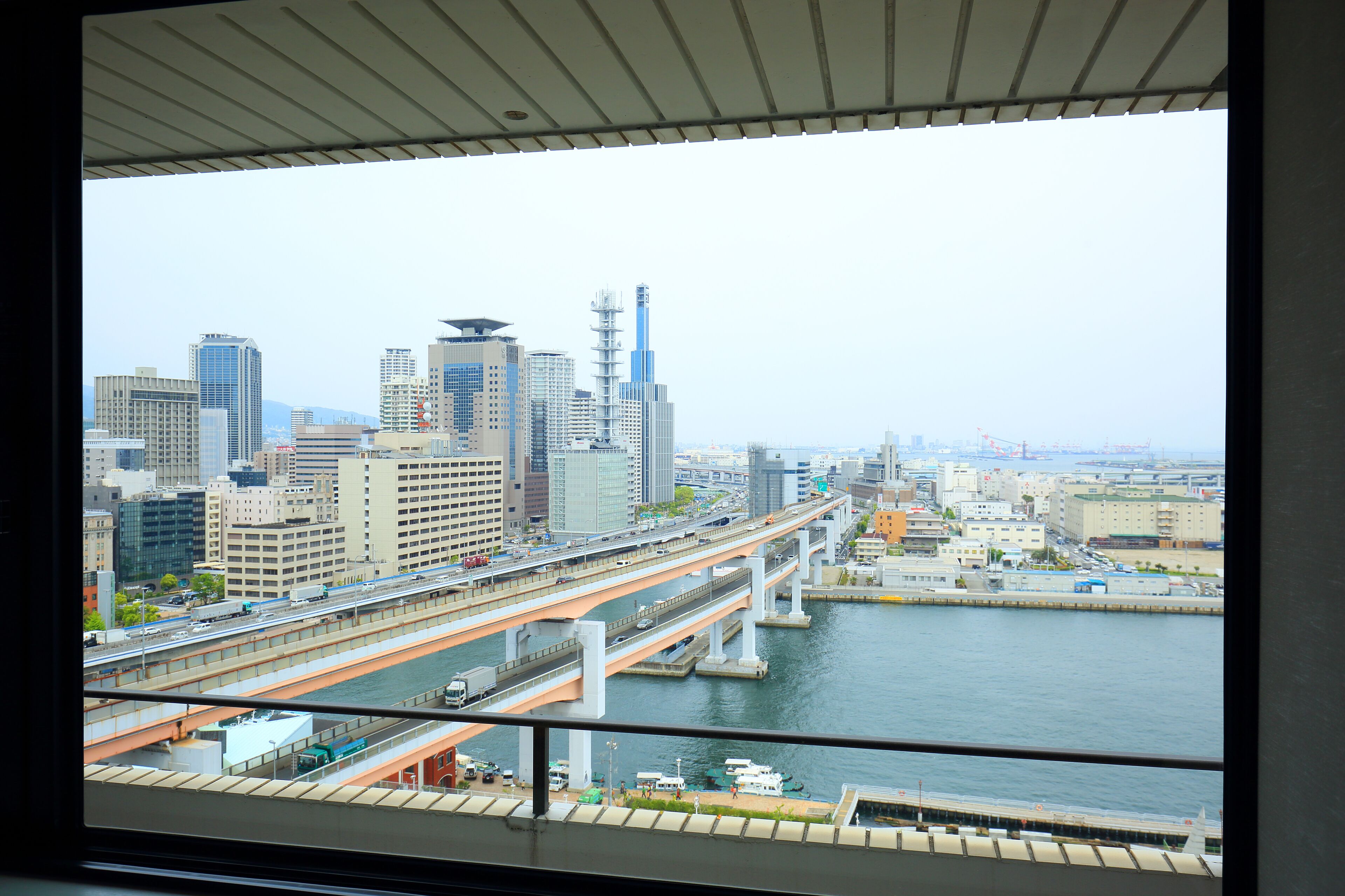 A cityscape with a river, multiple bridges, and high-rise buildings.
