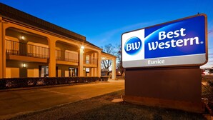 A Best Western Eunice hotel with a large illuminated sign, a covered outdoor area with railings, and a well-lit building facade. - Best Western Eunice (Eunice)