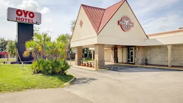 Welcome to Oyo Hotel, featuring a modern design with a flat roof and a unique triangular element.