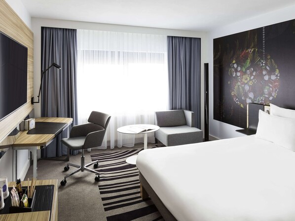 Enjoy a comfortable stay in this stylish room with a large bed, desk, and flat-screen TV.