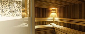 Una sauna con bancos de madera y una pared con mosaicos.