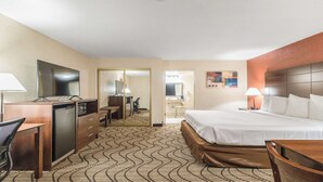 A hotel room with a bed, desk, chair, and a small kitchenette. - Best Western Roseville Inn (Roseville)