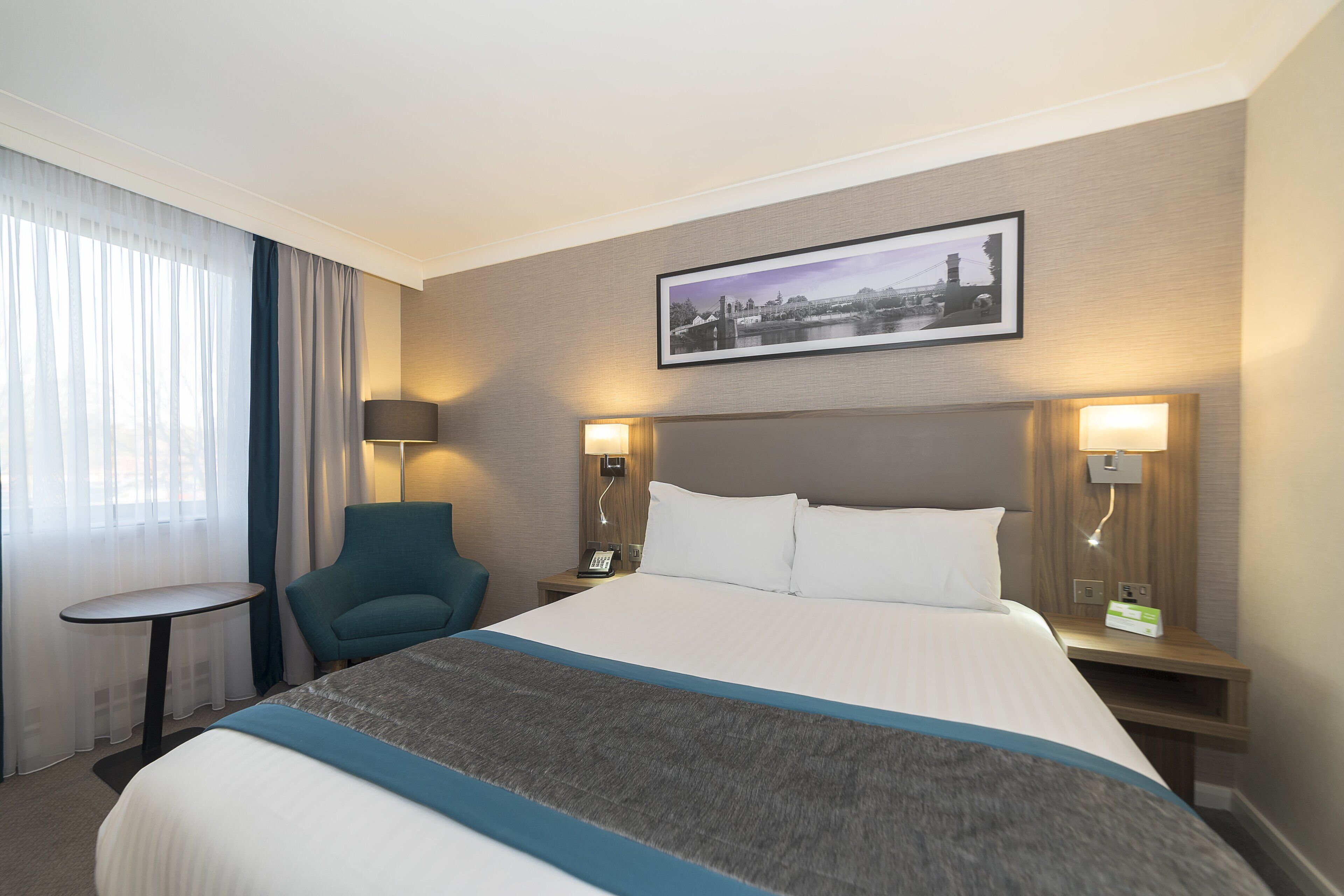 Hypo-allergenic bedding, desk, laptop workspace, blackout drapes