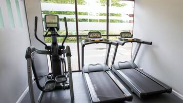 A gym with two treadmills and an elliptical machine.