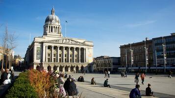 A large public square with a prominent neoclassical building featuring a dome and columns.