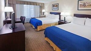 A hotel room with two beds, a desk, a chair, and a window with curtains. - Holiday Inn Express Little Rock Airport by IHG (Little Rock)