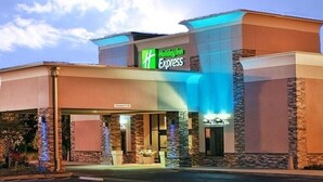 A Holiday Inn Express hotel with a modern design, featuring a prominent entrance and a clear sky in the background. - Holiday Inn Express Little Rock Airport by IHG (Little Rock)