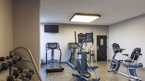 A gym with treadmills, elliptical machines, and dumbbells. - Hampton Inn Athens (Athens)