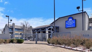 A hotel with a sign indicating it is the 'American Best Value Inn & Suites Extended Stay.'