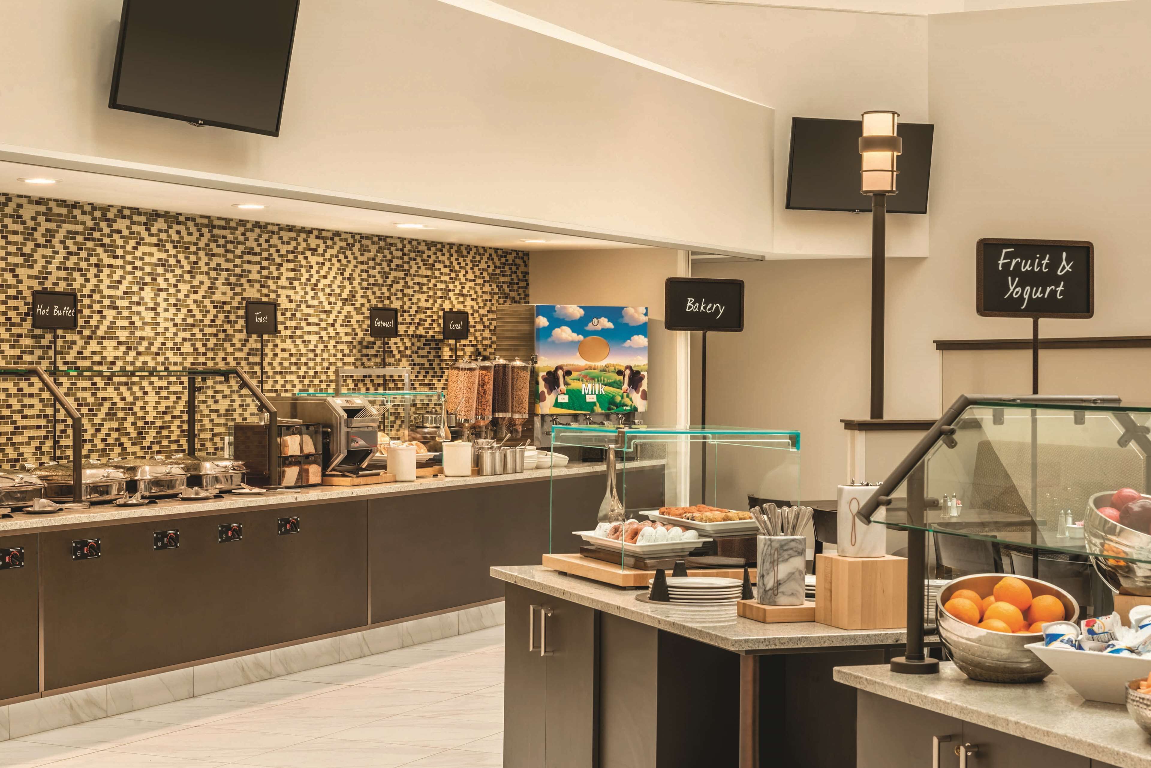 A modern breakfast bar with labeled sections for toast, cereal, and oatmeal.