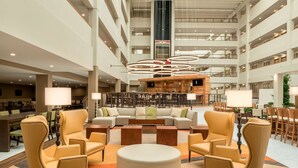 A spacious lobby with a central seating area, multiple floors, and a modern design.