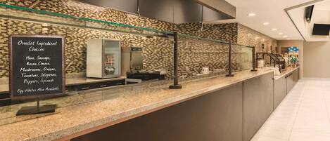 A modern breakfast bar with a chalkboard menu listing omelet ingredients and egg whites.