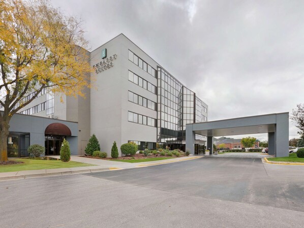 A modern building with a sign reading "Embassy Suites." It features a large entrance with a covered walkway, surrounded by well-maintained landscaping and a parking area. - Embassy Suites by Hilton Milwaukee Brookfield (Brookfield)