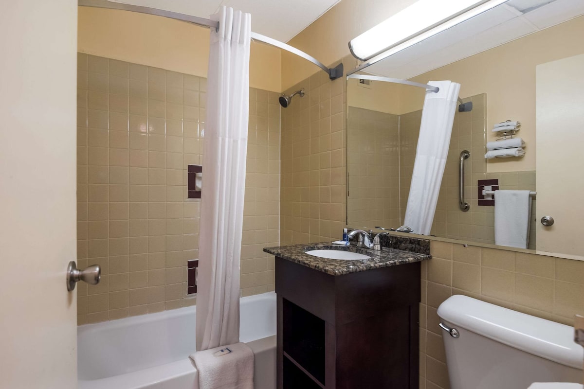 A bathroom with a bathtub, a sink, and a toilet.