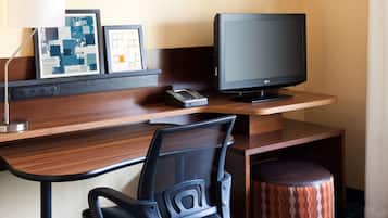 Premium bedding, desk, laptop workspace, blackout drapes