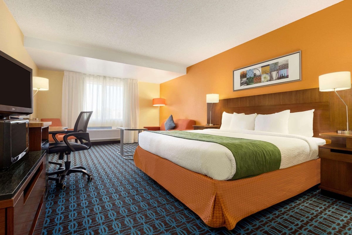 Premium bedding, desk, laptop workspace, blackout drapes