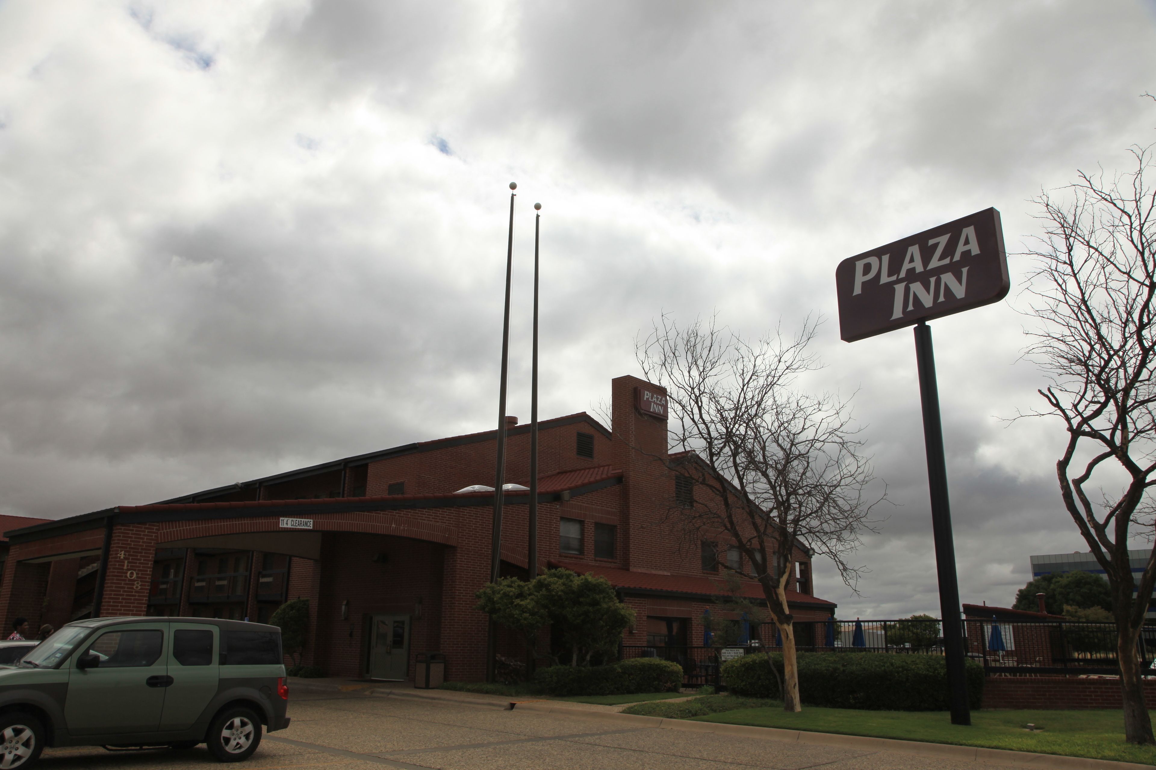 A brick building with a sign reading "Plaza Inn."