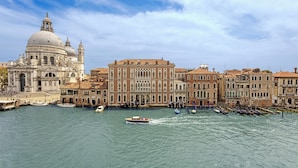 A historic building with a large dome and adjacent smaller structures, a canal with boats, and a clear sky. - The Gritti Palace, a Luxury Collection Hotel, Venice (Venice)