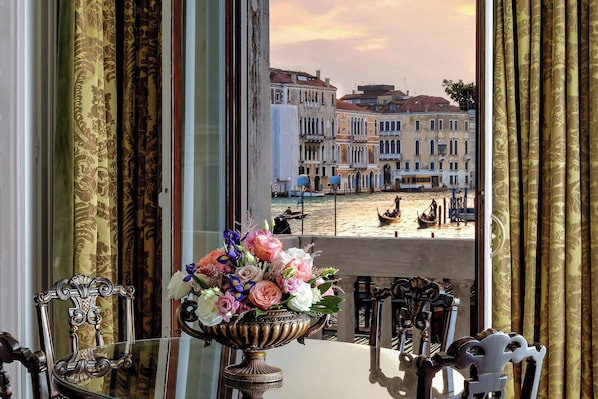 A table with a floral arrangement and ornate chairs, overlooking a waterfront with buildings and boats. - The Gritti Palace, a Luxury Collection Hotel, Venice (Venice)