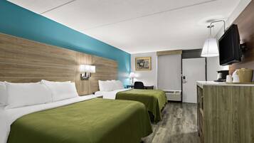 A hotel room with two beds, a desk, a TV, and a painting on the wall.
